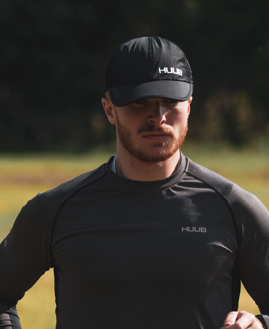 HUUB Race Cap II – mesh, flat panel, race running cap in Coral, White, or Black, ultra-lightweight and adjustable.